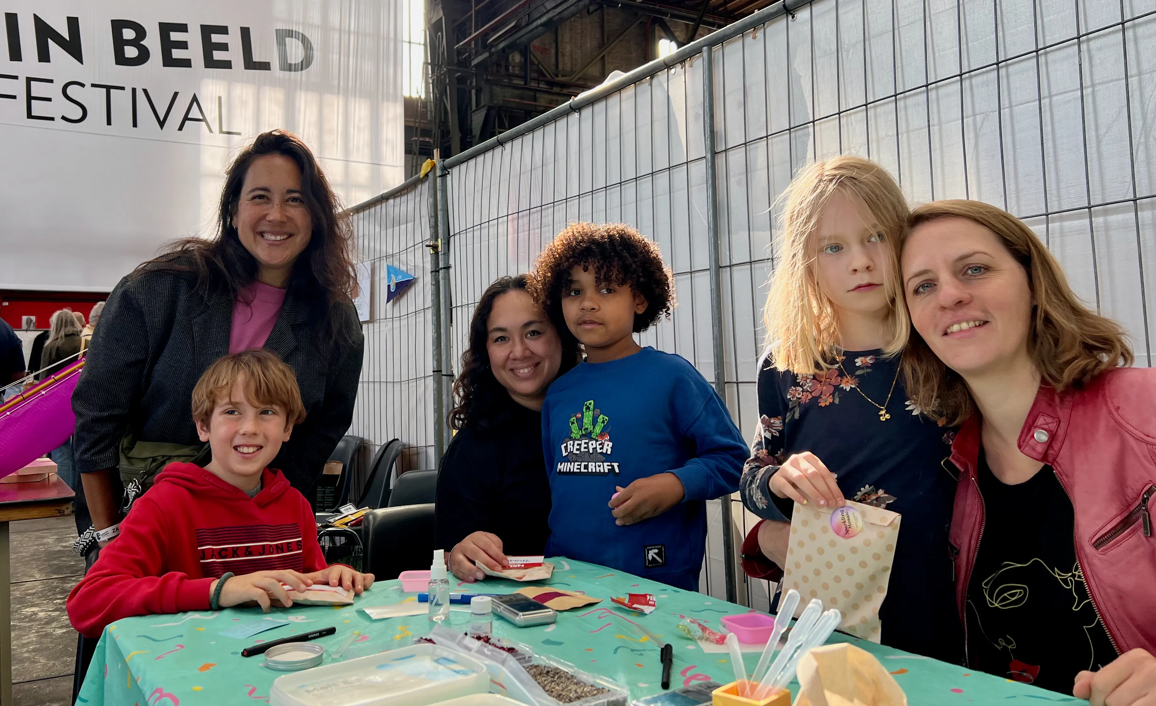 Child and parent holding up their handmade soap bars after a kids workshop